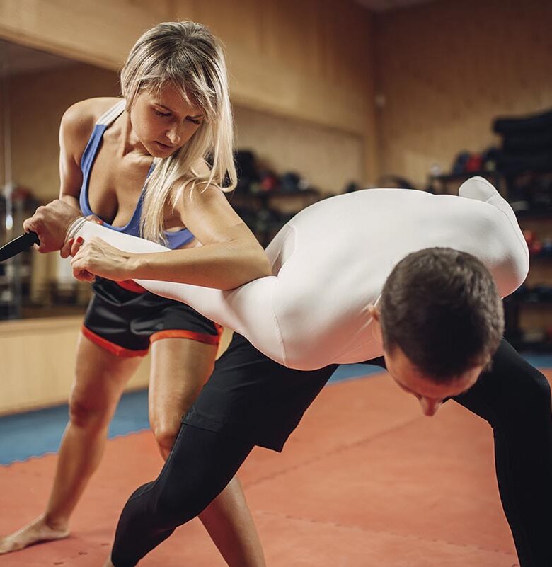 Woman makes elbow kick, self defense workout