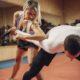 Woman makes elbow kick, self defense workout