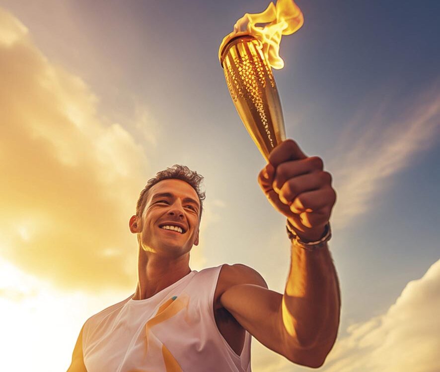 A happy smiling male athlete solemnly carries the Olympic flame