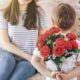 Boy holding a bouquet of flowers behind his back