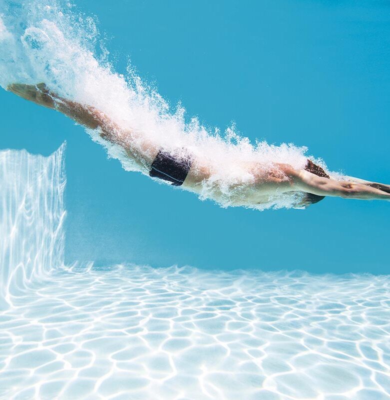 Man diving into swimming pool