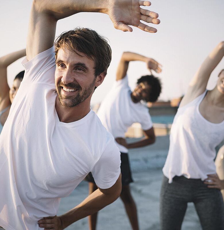 Fitness, sport, friendship and healthy lifestyle concept . Group of happy people exercising