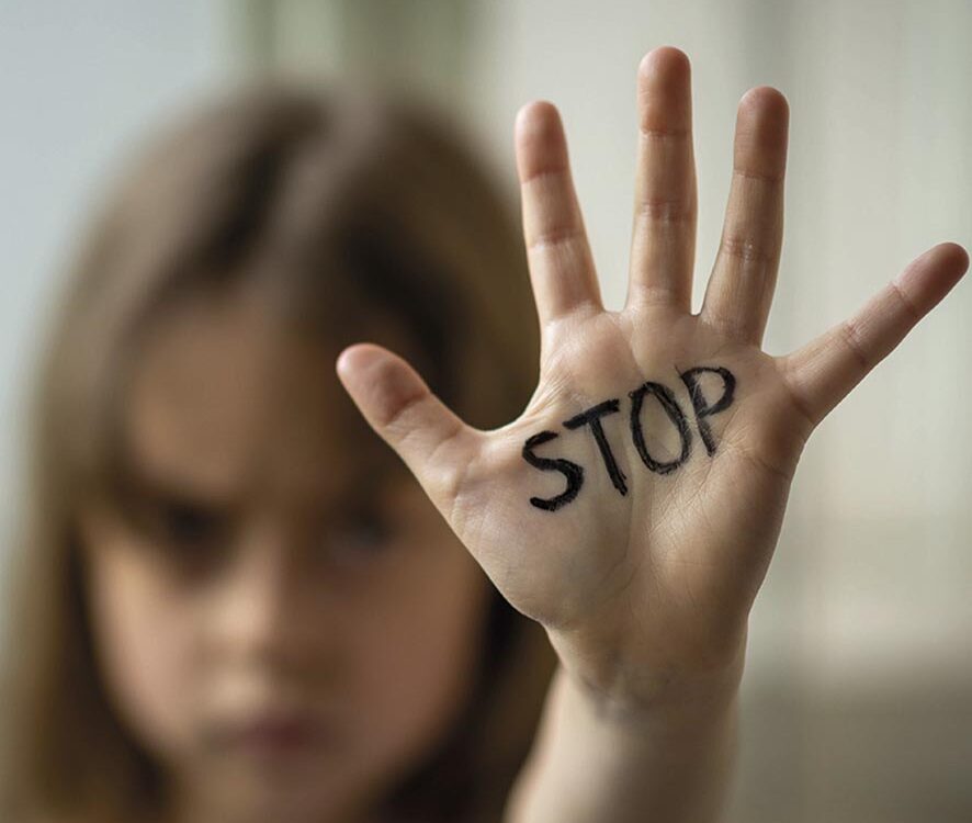 The child makes a stop gesture with his hand. Stop domestic and child abuse.