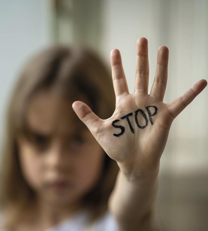 The child makes a stop gesture with his hand. Stop domestic and child abuse.