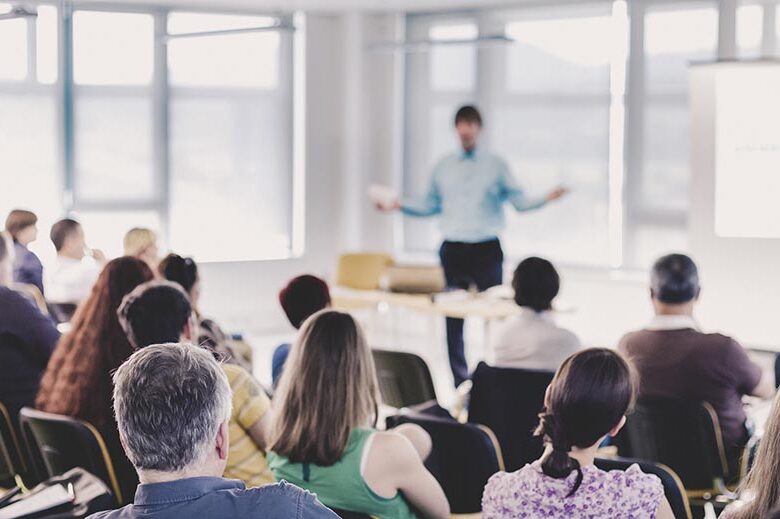 Speaker Giving a Talk at Business Meeting.