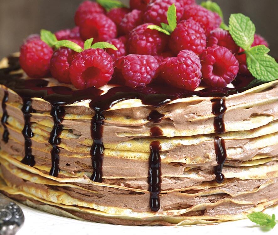 Pancake chocolate cake with fresh raspberry.